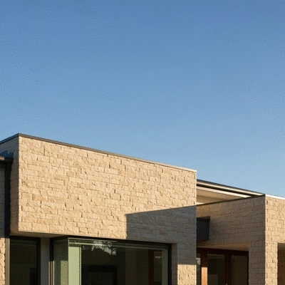 Modern house exterior with elegant stone cladding under a clear Australian sky