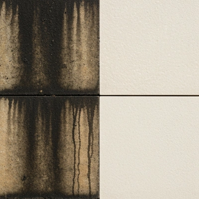 Before and after comparison of a stone cladding section, showing significant improvement after cleaning